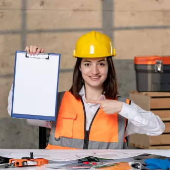 Professional carpenter using a hammer on a wooden roof structure under a blue sky in Los Angeles.