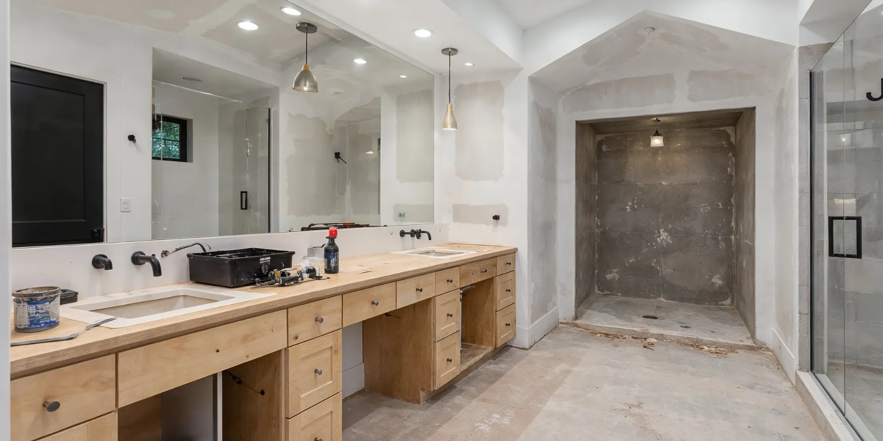 Bathroom remodeling project in Los Angeles before completion with unfinished vanity and shower area