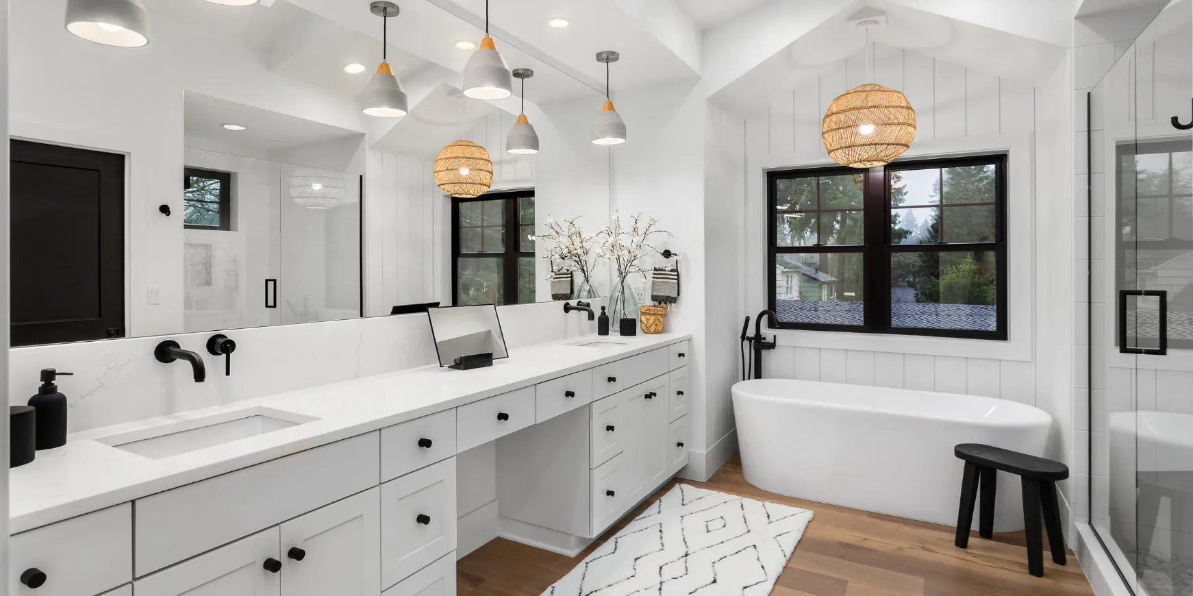 Modern bathroom remodeling project in Los Angeles with freestanding tub, double vanity, and contemporary lighting
