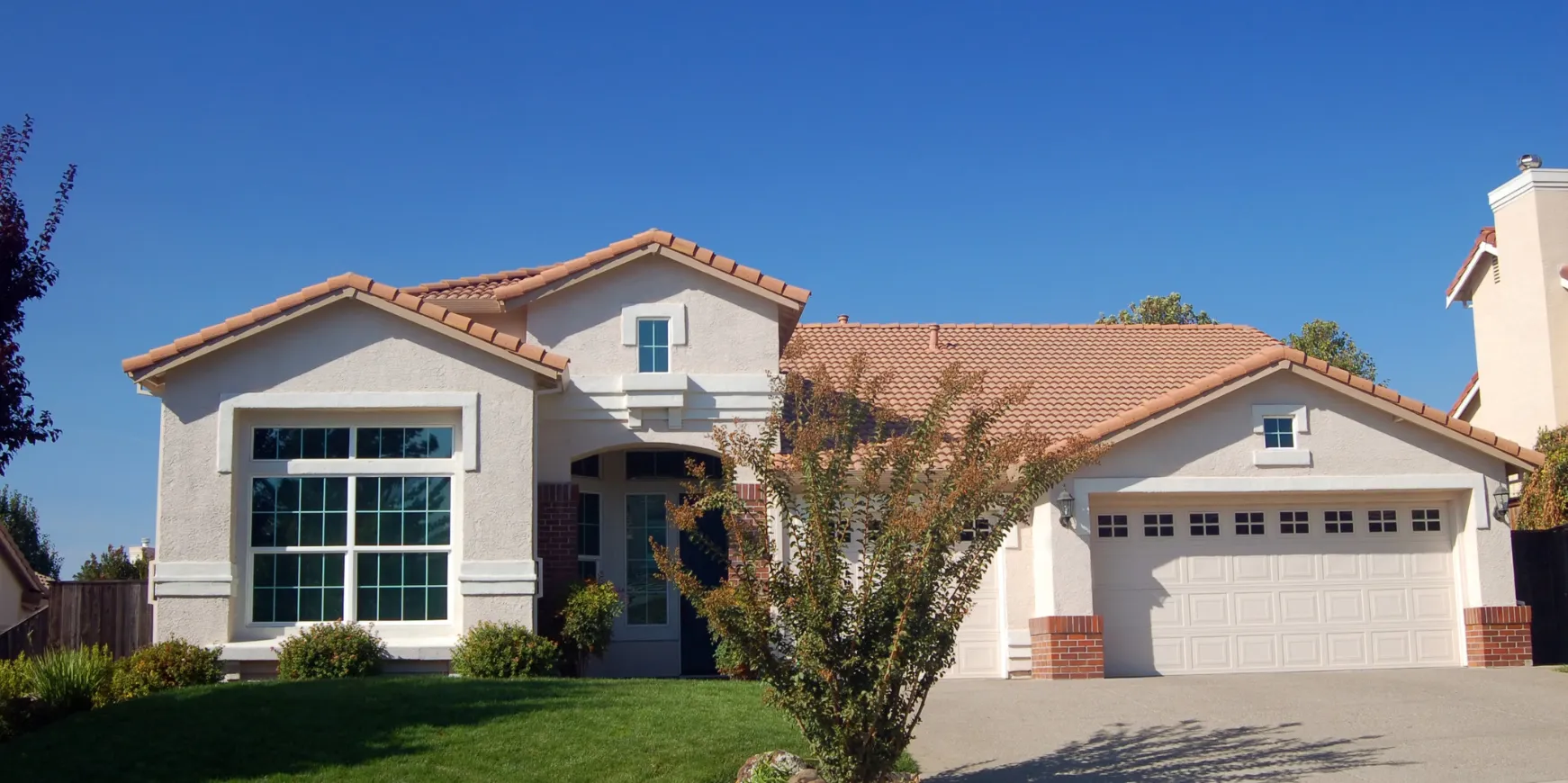 Completed new construction home in Los Angeles featuring finished exterior, driveway, landscaping, and modern design